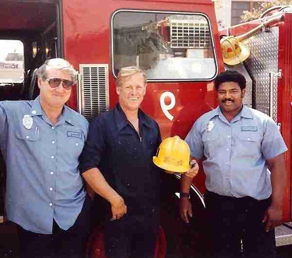 Three Firefighters standing in front of the driver's door of Engine 9. Firefighter Anthony Jefferson, Engineer Jimmy Howe & Captain Emmet Kinney